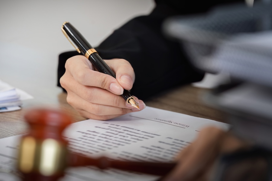 signing legal documents with pen in office setting 2026 01 07 00 51 28 utc